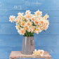 A bouquet of Replete daffodils in a blue vase on a wooden table.
