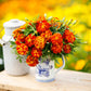 Marigold organic sparky mix orange and red blooms in a pot with green foliage.