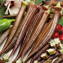 Several elongated Red Burgundy okra showing its deep red skin and green stems.