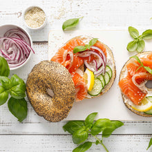 A bagel using sliced Red Grano onions as one of the toppings.