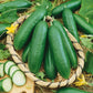 A brown basket containing several Diva Cucumbers with smooth dark green skin.