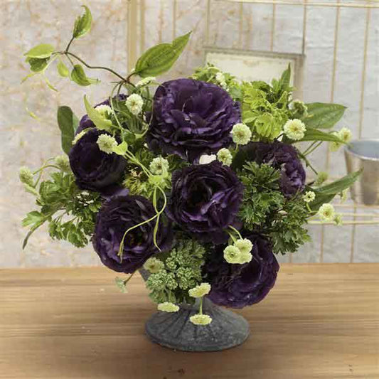 Lisianthus black pearl deep purple blooms with green buds in a bright studio setting.